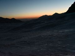 04B The first rays of daylight on the horizon at crampon point on the way to Ak-Sai Travel Lenin Peak Camp 2 5400m